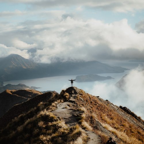 man-with-hands-wide-open-standing-top-mountain-enjoying-incredible-view-lake-181624-50789.jpg